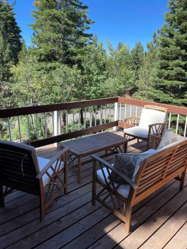 a deck with a picnic table and chairs on it at Kitzbuhel Paradise Sleeps 8 in Truckee