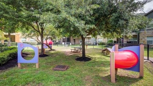 a park with a playground with a red slide at Landing at Residences at River Park West - Richmond in Richmond