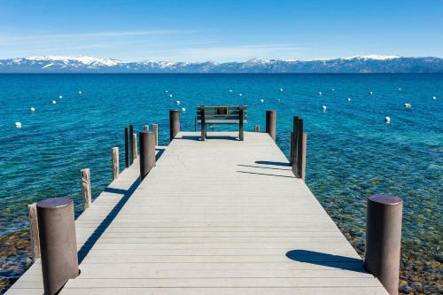 a wooden dock in the middle of the water at Waters Edge Escape - Patio with BBQ Near Beach in Tahoma