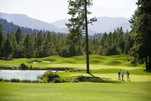 a group of three people standing on a golf course at Suncadia 4 Bdrm Home with Private Hot Tub in Cle Elum