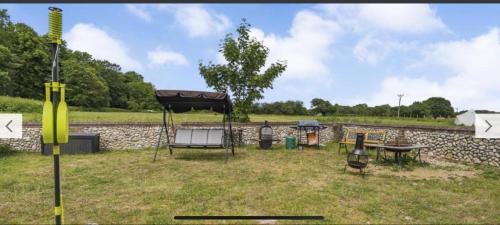 a park with a bench and a picnic table at The Ducks - Gorgeous Norfolk Upside down Cottage - with Lazy Spa in Mileham