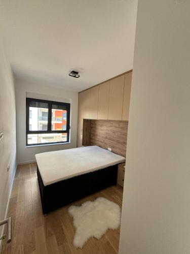 a bedroom with a large bed in a room at Apartman Andrea in Trebinje