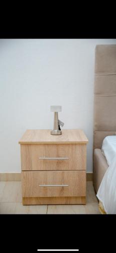a nightstand with a lamp on it next to a bed at Villa 59 in Shkodër