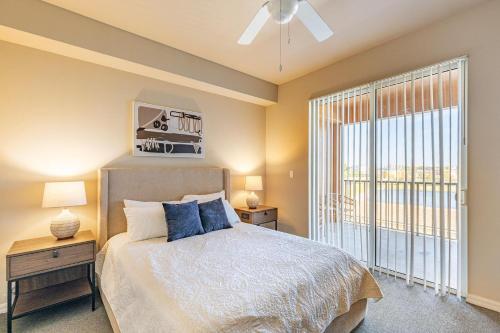 a bedroom with a bed and a large window at Landing Fort Myers near Heritage Palms in Fort Myers