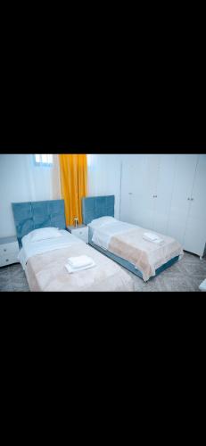 a bedroom with two beds and a window at Villa 59 in Shkodër
