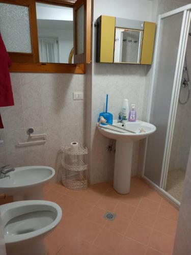 a bathroom with a toilet and a sink at Casa Serena 2 in Scanno