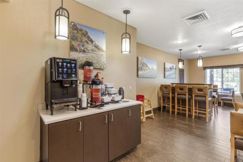a kitchen with a coffee maker on top of a counter at Best Western Plus Riverfront Hotel and Suites in Great Falls