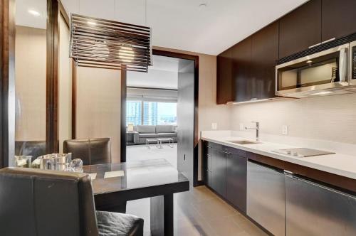 a kitchen with a counter and a dining room at Luxurious Vdara High Rise Room, City Skyline Views, King Bed, Free Valet in Las Vegas