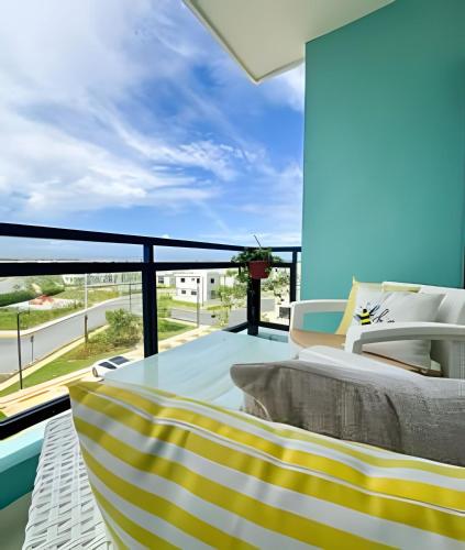 a balcony with a bed and a view of a building at Epic Punta Cana in Punta Cana