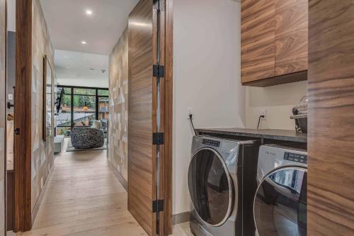 a laundry room with a washer and dryer in it at One Snowmass West 603 by Snowmass Mountain Lodging in Snowmass