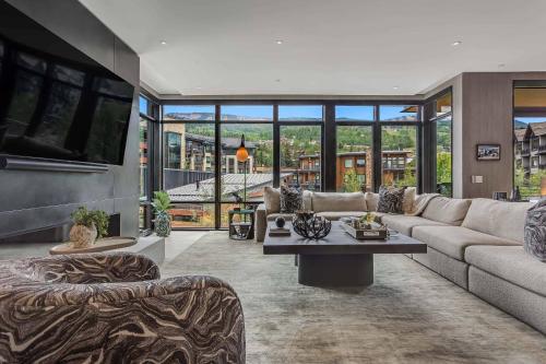 a living room with a couch and a table at One Snowmass West 603 by Snowmass Mountain Lodging in Snowmass