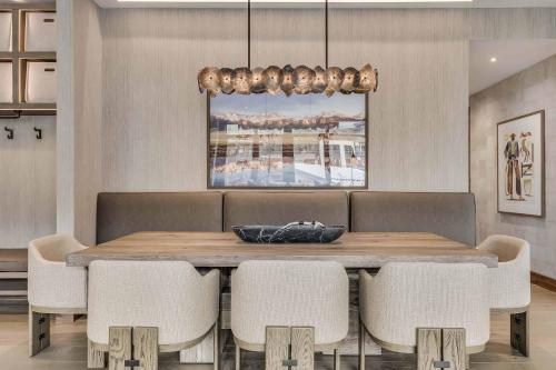 a dining room with a wooden table and chairs at One Snowmass West 603 by Snowmass Mountain Lodging in Snowmass