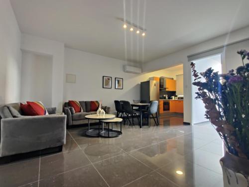 a living room with a couch and a table at Central 2 bdr Flat St Lazaros -Arsinoe Lodge in Larnaka