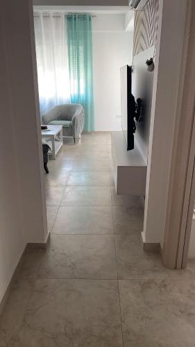 a living room with a couch and a tiled floor at MBv Budva in Budva