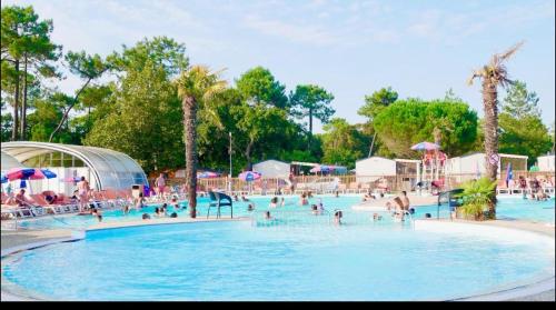 a group of people in a pool at a resort at Mobil home Cap ferret les viviers siblu in Lège-Cap-Ferret