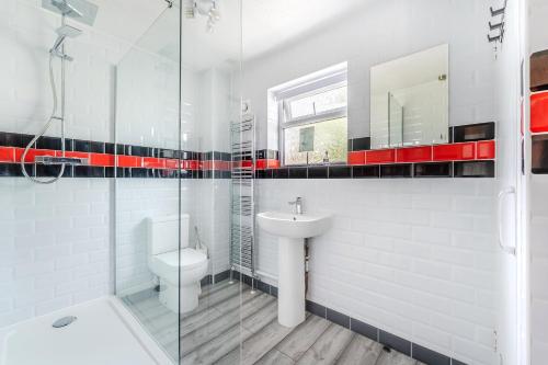 a white bathroom with a sink and a toilet at Modern 3 bed House in Upton
