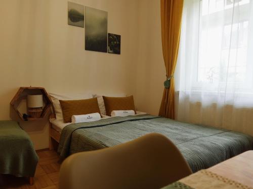 a bedroom with two beds and a window at Willa Krynica in Krynica Zdrój
