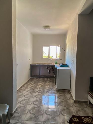 an empty kitchen with a sink and a counter at MG Zarzis 4 in Zarzis