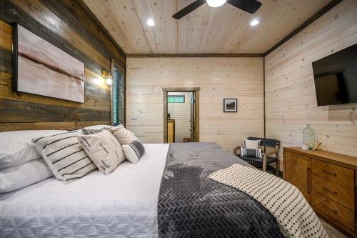 a bedroom with a bed and a television in it at Luxury Cabin- Sleeps 12- Hot Tub - Dog Friendly in Broken Bow