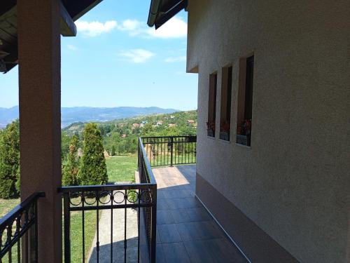 a balcony of a house with a view of the mountains at Holiday Home Dzeni in Zenica