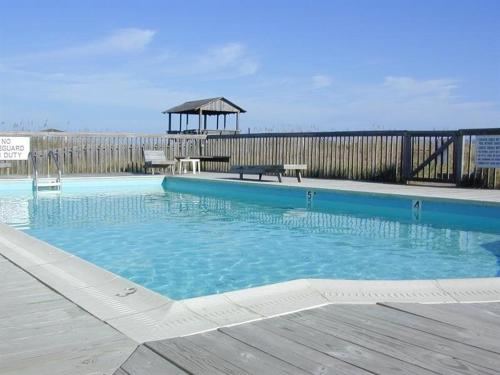a large swimming pool with a gazebo in the background at SO1A - Shangri-La in Kill Devil Hills