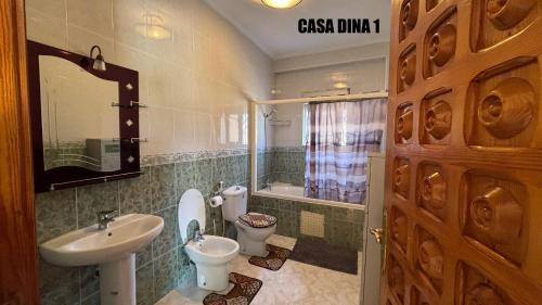 a bathroom with a sink and a toilet and a mirror at CASA DINA 1 in Melîyech