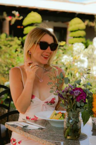 a woman sitting at a table with a plate of food at Hacienda San Angel in Ensenada