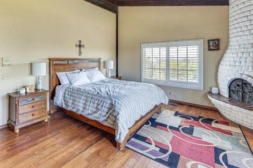 a bedroom with a bed and a cross on the wall at Stunning Valley and Mtn Views Elegant Temecula Home in Temecula