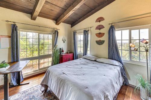 a bedroom with a bed in a room with windows at Stunning Valley and Mtn Views Elegant Temecula Home in Temecula