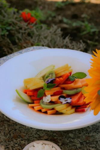 a white plate of vegetables on a table at Hacienda San Angel in Ensenada
