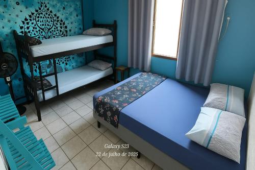 a bedroom with a bed and a bunk bed at Mandallah Hostel in Joinville
