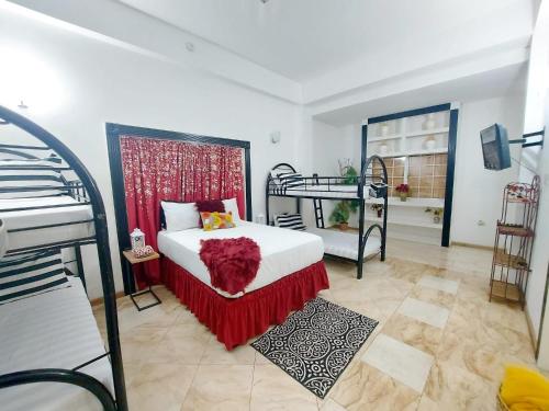 a bedroom with two bunk beds and a bed with red blanket at Kingston Manor Vacation Homes in Kingston