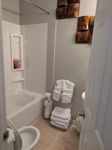 a white bathroom with a tub and a sink at 197 Le Maire Street in Winnipeg