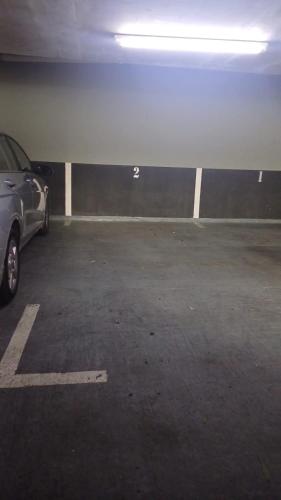 a parking garage with a car parked in it at HOM I 2D2B Parking, piscina temperada y gimnasio in Puerto Varas