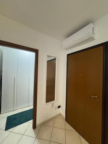 an empty room with a door and a window at Reggio Emilia Apartments - Giardino - Uno in Reggio Emilia