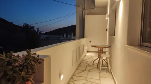 a small balcony with a stool and a window at Marina's House in Kinídharos
