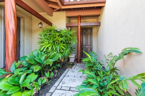 a porch of a house with plants in front of it at Mauna Lani Fairways - Luxury Accommodations in Waikoloa