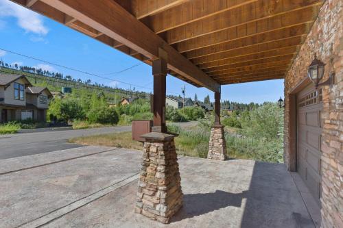 an outdoor patio with a wooden roof over a garage at Mule Meadows - Classy Split level South Tahoe home in South Lake Tahoe