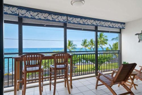 a dining room with a view of the ocean at Kona Alii - Oceanview Pool Shops & Restaurants in Kailua-Kona