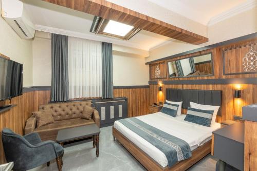 a bedroom with a bed and a couch at La Serena Taksim in Istanbul