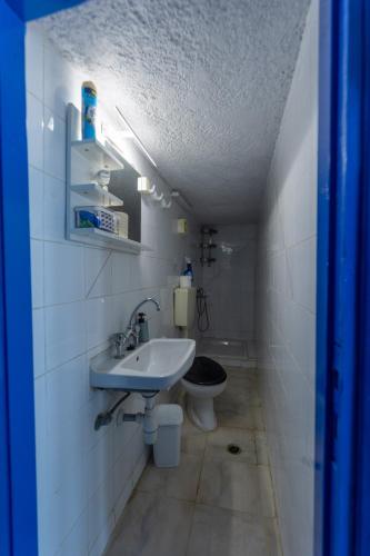 a bathroom with a sink and a toilet at Phone Booth in Koutsounari