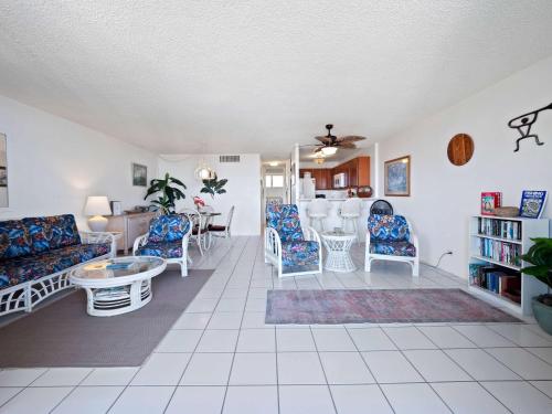 a living room with a couch and chairs and a table at Kolu Honu - Stunning Beachfront Condo for 2 in Kailua-Kona