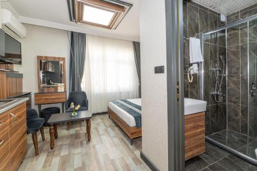 a hotel room with a bed and a bathroom at La Serena Taksim in Istanbul