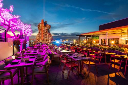 a restaurant with tables and chairs at night at KOOSH - Boutique Aparthotel in Fort Lauderdale