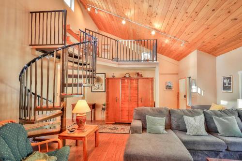 a living room with a couch and a spiral staircase at Tahoe Family Getaway in Stateline