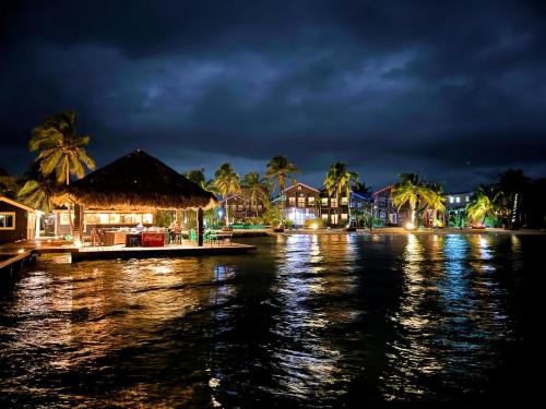 a night view of a resort on a body of water at X'tan Ha- The Waterfront in San Pedro