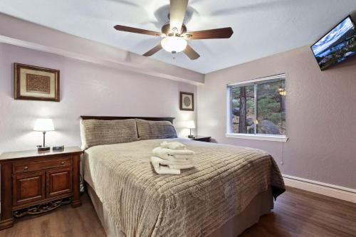 a bedroom with a bed with a ceiling fan at Ski In Ski Out 3 BDR Steps from Stagecoach Lift in Stateline