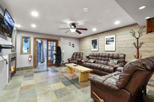 a living room with leather furniture and a ceiling fan at Ski In Ski Out 3 BDR Steps from Stagecoach Lift in Stateline