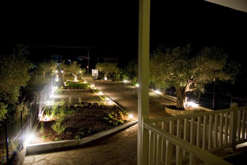 a view of a park at night with lights at Olivegrove House in Vourvourou