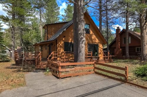 a cabin in the woods with a tree at Christmas Valley Chalet - Tahoe Adventure Awaits in South Lake Tahoe